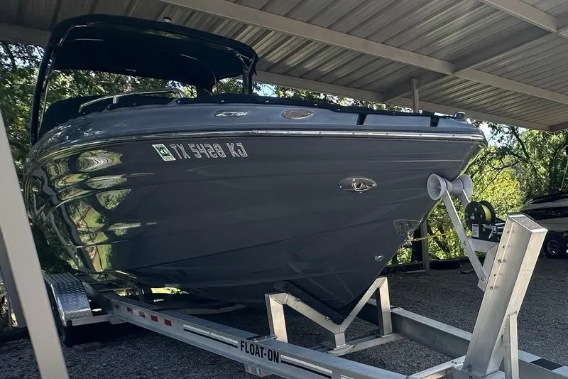 Slide: The Image of 2017 Cruisers Sport Series 298 SS South Beach Edition boat on trailer under shelter. - 9