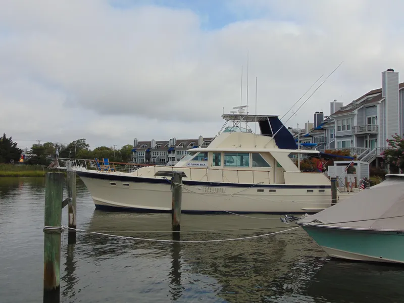 The Image of 1972 Hatteras Yachtfish being lifted for maintenance at a marina. - 0