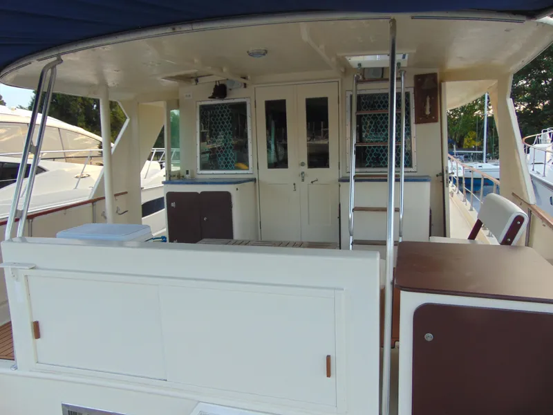 Slide: The Image of 1972 Hatteras Yachtfish on stands, blue hull, gravel ground. - 12