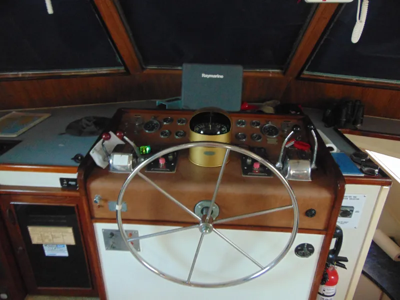 Slide: The Image of 1972 Hatteras Yachtfish deck with wooden flooring and seating area. - 14