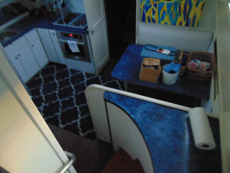 Slide: The Image of 1972 Hatteras Yachtfish interior with seating and storage, featuring classic design elements. - 15