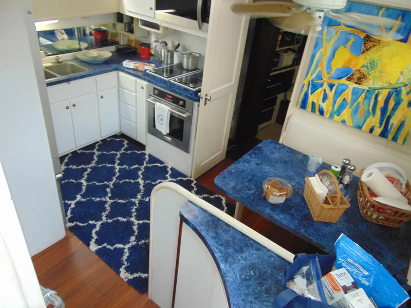Slide: The Image of Interior of a 1972 Hatteras Yachtfish with cozy seating and nautical decor. - 16