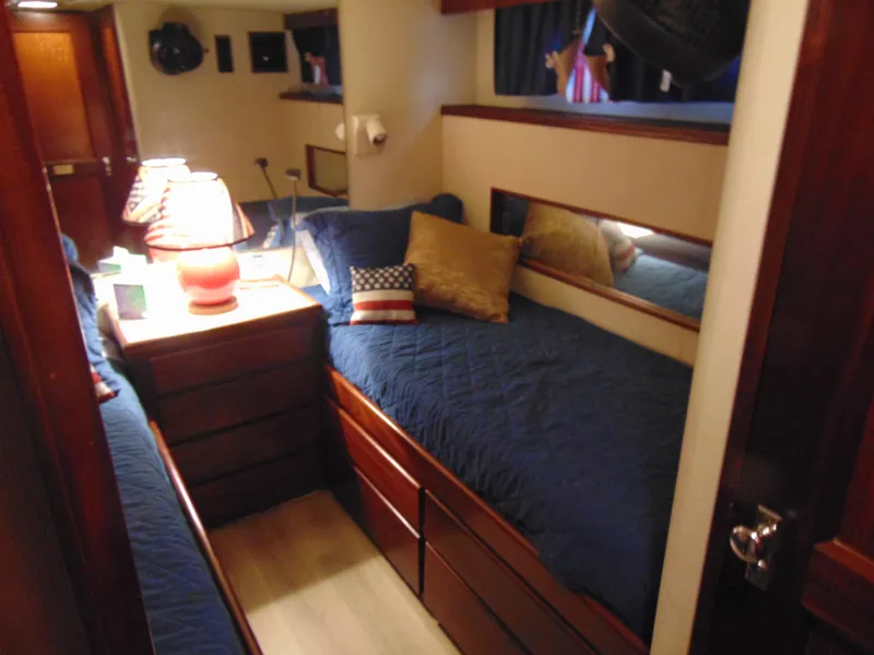 Slide: The Image of Interior of 1972 Hatteras Yachtfish with kitchen and dining area, featuring blue countertops. - 18