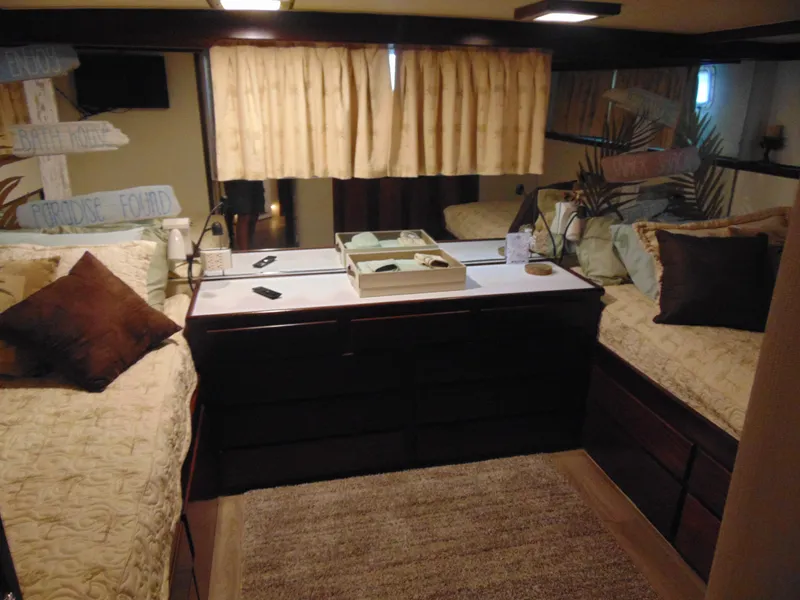 Slide: The Image of 1972 Hatteras Yachtfish interior kitchen with blue countertops and rug, modern appliances, and vibrant artwork. - 19