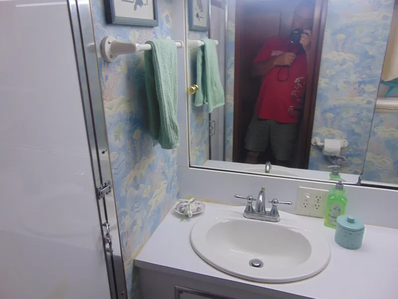 Slide: The Image of Cozy 1972 Hatteras Yachtfish cabin with twin beds and nautical decor. - 21