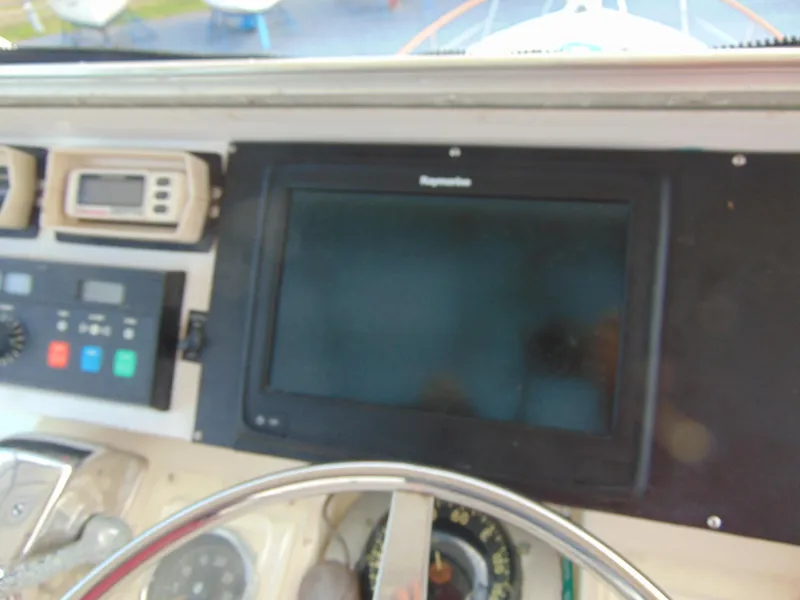 Slide: The Image of Interior shower area of a 1972 Hatteras Yachtfish, featuring a showerhead and toiletries. - 25