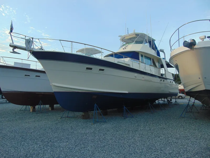 Slide: The Image of 1972 Hatteras Yachtfish docked near waterfront homes. - 3