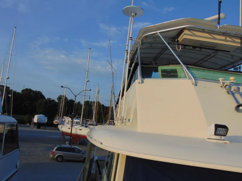 Slide: The Image of 1972 Hatteras Yachtfish with blue cover and kayak on deck. - 31