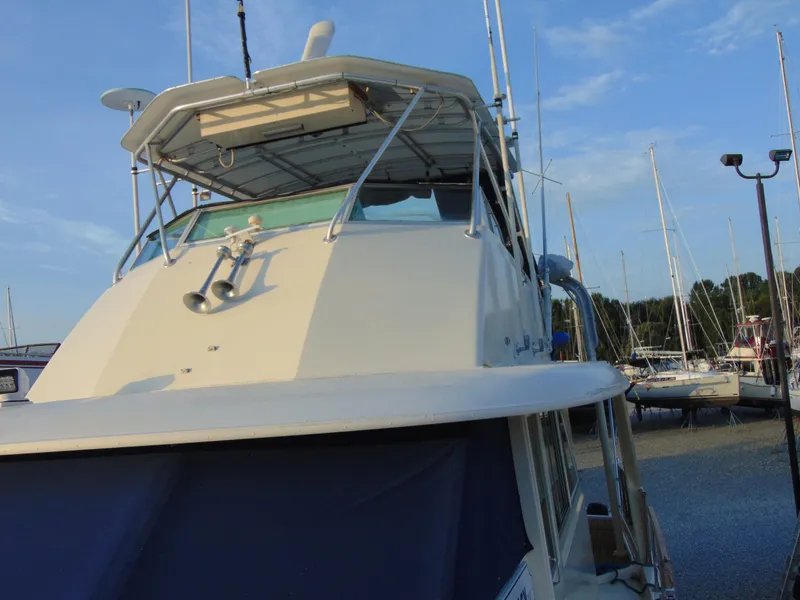 Slide: The Image of 1972 Hatteras Yachtfish on water, featuring spacious deck and classic design. - 32