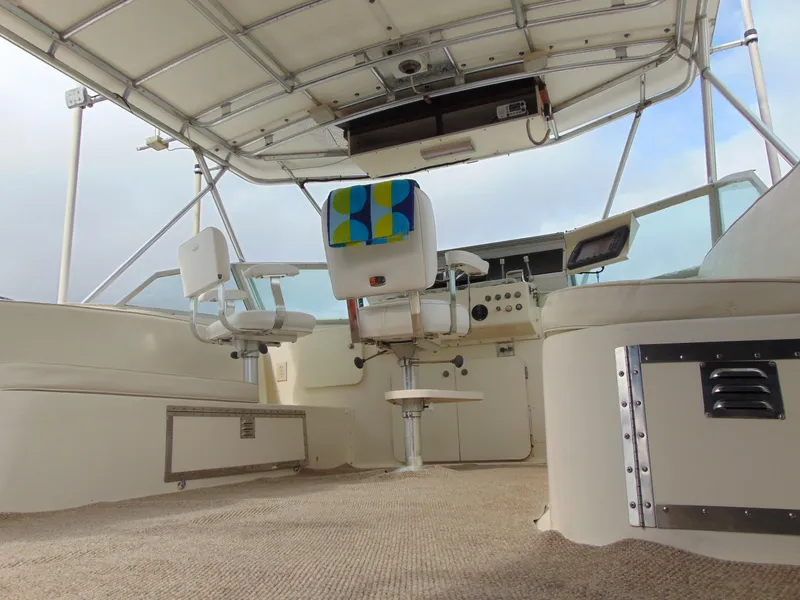 Slide: The Image of 1972 Hatteras Yachtfish deck with teak flooring and seating area. - 39