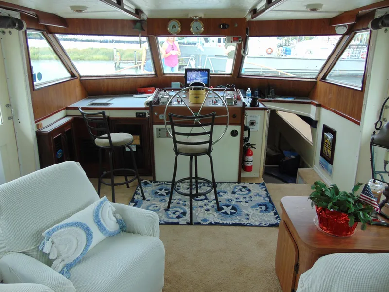 Slide: The Image of 1972 Hatteras Yachtfish interior with helm, seating, and nautical decor. - 41