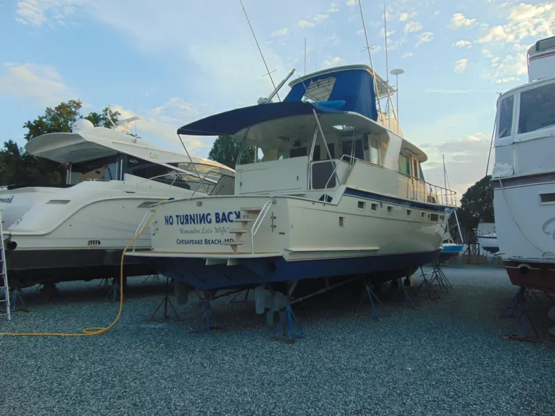 Slide: The Image of 1972 Hatteras Yachtfish with people relaxing on deck in a marina setting. - 5