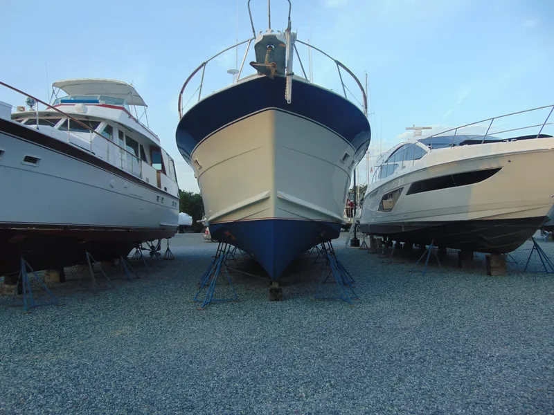 Slide: The Image of 1972 Hatteras Yachtfish docked at Chesapeake Beach, MD, under a clear sky. - 7