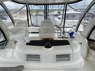 Slide: The Image of 2007 Sea Ray 52 Sedan Bridge yacht interior with helm and seating area. - 11