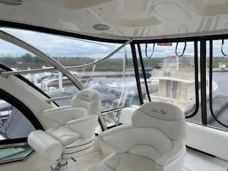 Slide: The Image of Interior of 2007 Sea Ray 52 Sedan Bridge yacht with plush seating and panoramic windows. - 13