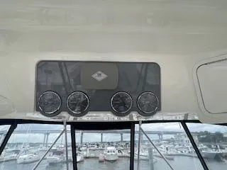 Slide: The Image of 2007 Sea Ray 52 Sedan Bridge dashboard with gauges, overlooking marina. - 16