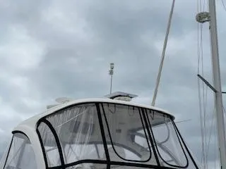 Slide: The Image of 2007 Sea Ray 52 Sedan Bridge yacht with enclosed flybridge under cloudy skies. - 20