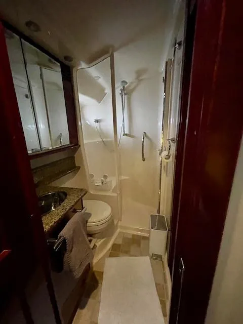 Slide: The Image of 2007 Sea Ray 52 Sedan Bridge bathroom with shower, sink, and toilet. - 28