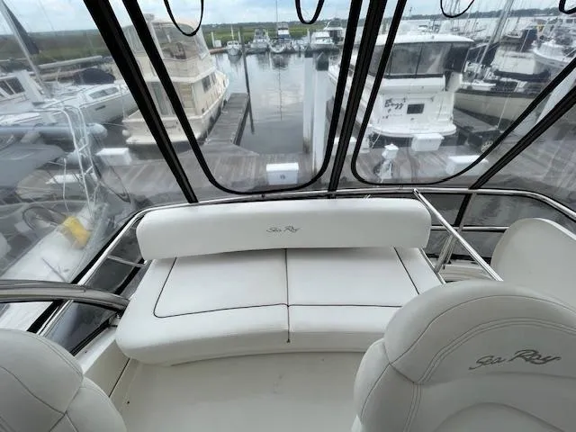 Slide: The Image of 2007 Sea Ray 52 Sedan Bridge interior with marina view, featuring white seating. - 29