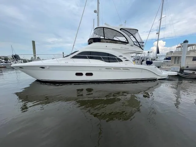 Slide: The Image of 2007 Sea Ray 52 Sedan Bridge yacht docked in marina, side view. - 3