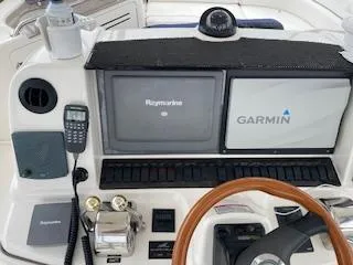 Slide: The Image of 2007 Sea Ray 52 Sedan Bridge helm with Raymarine and Garmin navigation systems. - 40