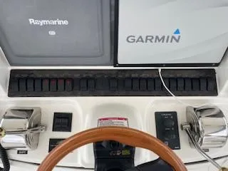 Slide: The Image of 2007 Sea Ray 52 Sedan Bridge helm with Raymarine and Garmin navigation systems. - 41