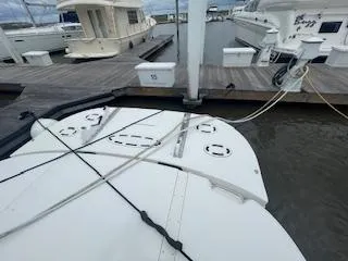 Slide: The Image of 2007 Sea Ray 52 Sedan Bridge docked at marina, view of stern and mooring lines. - 44
