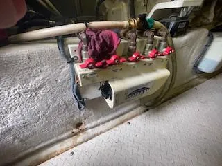 Slide: The Image of 2007 Sea Ray 52 Sedan Bridge engine room with valve controls and hoses. - 49