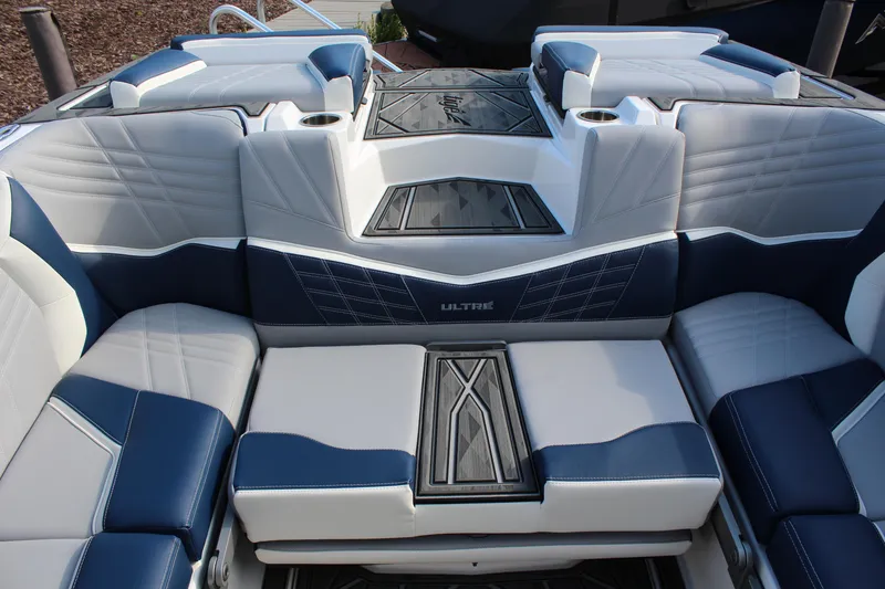 Slide: The Image of 2025 Tigé Ultré 25ZX boat interior with blue and white seating, modern design. - 11