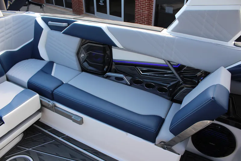 Slide: The Image of 2025 Tigé Ultré 25ZX boat interior with blue and white seating and cup holders. - 12