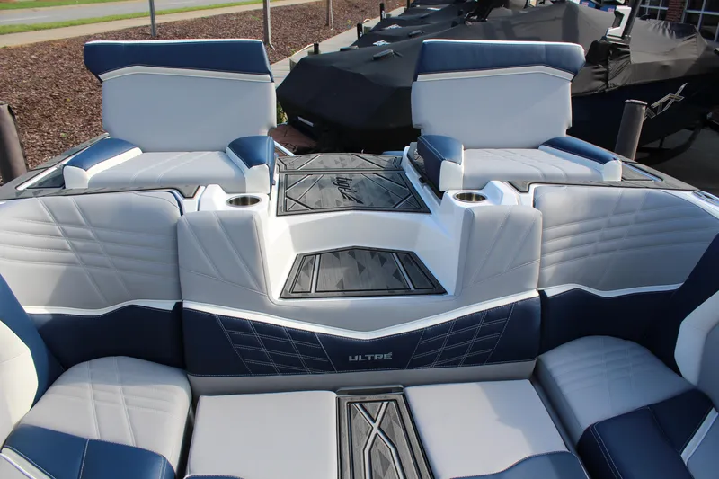 Slide: The Image of 2025 Tigé Ultré 25ZX boat interior with blue and white seating and cup holders. - 14