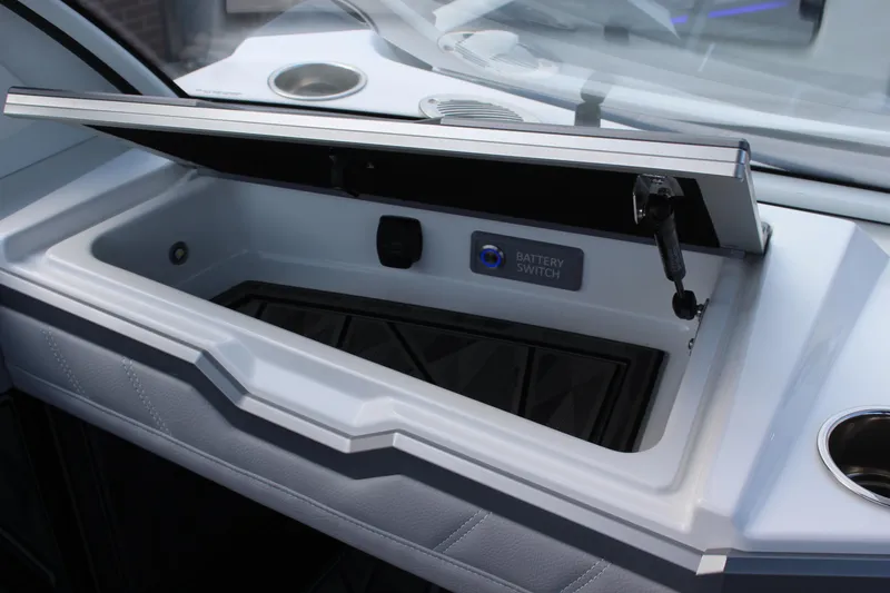 Slide: The Image of Open storage compartment in 2025 Tigé Ultré 25ZX boat dashboard. - 19