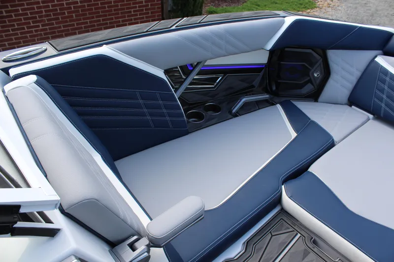 Slide: The Image of 2025 Tigé Ultré 25ZX interior with sleek blue and gray seating design. - 21