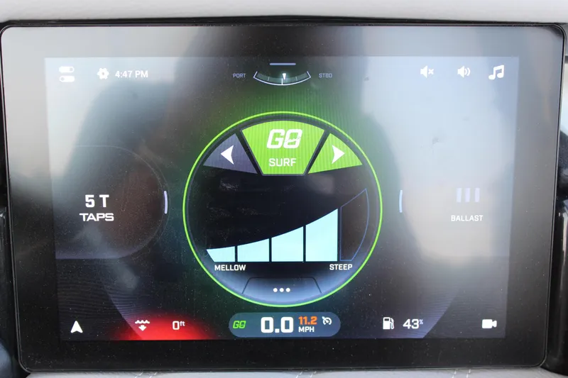 Slide: The Image of 2025 Tigé Ultré 25ZX touchscreen display showing surf settings and speedometer. - 25