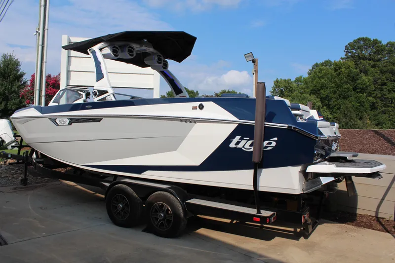 Slide: The Image of 2025 Tigé Ultré 25ZX boat on trailer, sleek design, blue and white color scheme. - 3