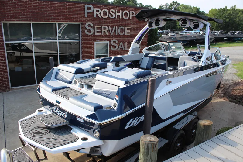 Slide: The Image of 2025 Tigé Ultré 25ZX boat displayed at a dealership, showcasing sleek design and modern features. - 5