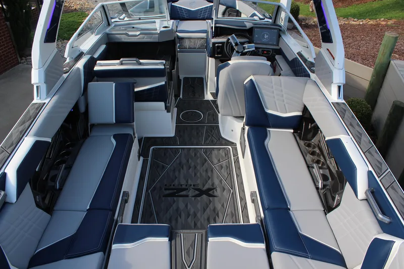 Slide: The Image of 2025 Tigé Ultré 25ZX boat interior with luxurious seating and modern dashboard. - 8