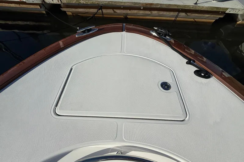 Slide: The Image of 2026 Mag Bay 38 CC boat interior with logo and wooden accents. - 20