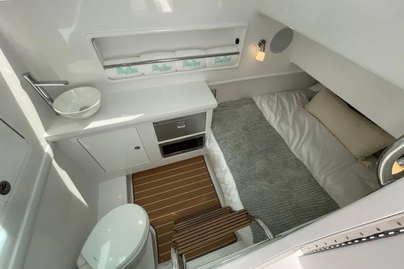 Slide: The Image of Storage compartment filled with water bottles on a 2026 Mag Bay 38 CC boat. - 22