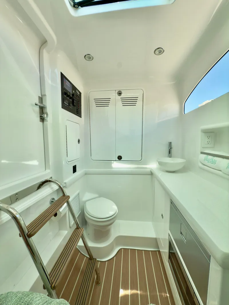 Slide: The Image of 2026 Mag Bay 38 CC boat interior with luxurious seating and sleek design at a marina. - 24