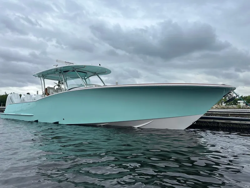 Slide: The Image of 2026 Mag Bay 38 CC boat with dual Mercury 600 V12 engines, docked at sunset. - 3