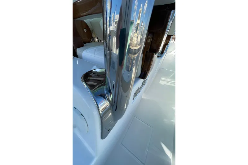 Slide: The Image of 2026 Mag Bay 38 CC boat with sleek design and modern features at a boat show. - 32