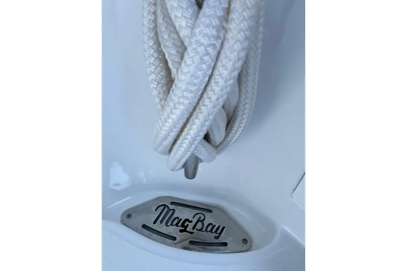 Slide: The Image of Sleek cleat on 2026 Mag Bay 38 CC boat, reflecting sunlight on polished wood. - 37