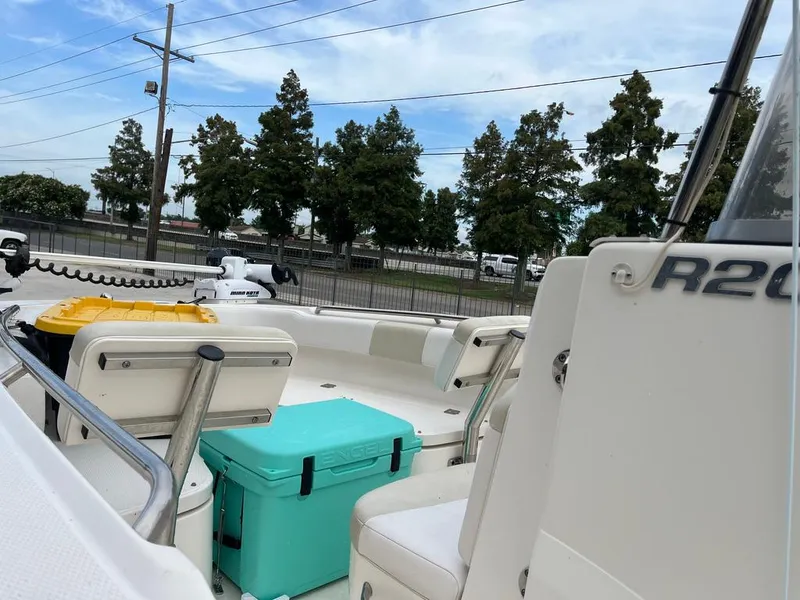 Slide: The Image of 2016 Robalo R200 Center Console boat with seating and storage, docked outdoors. - 13