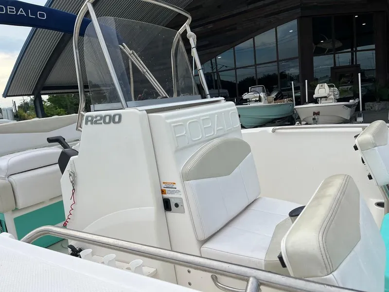 Slide: The Image of 2016 Robalo R200 Center Console boat interior with white seating and console. - 16