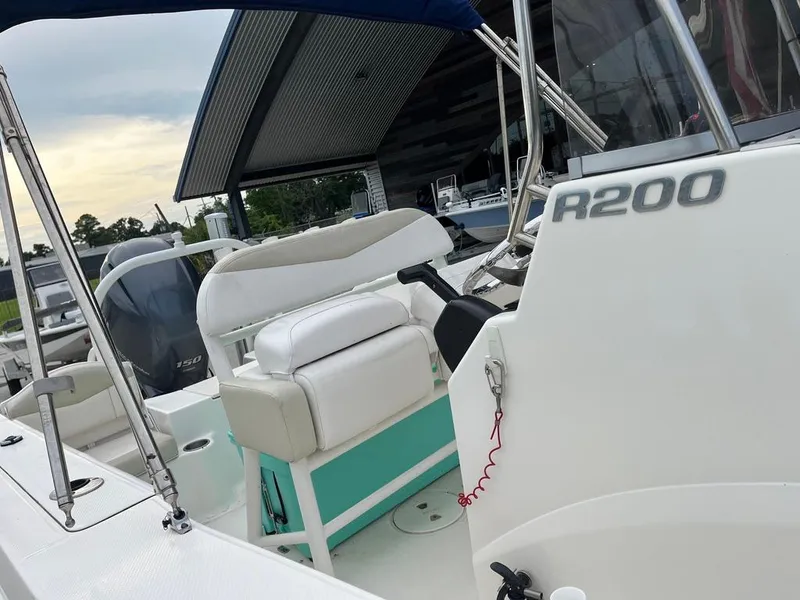 Slide: The Image of 2016 Robalo R200 Center Console boat interior with seating and controls. - 17