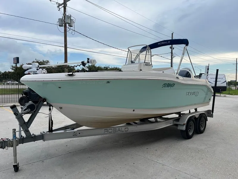 Slide: The Image of 2016 Robalo R200 Center Console boat on trailer, parked outdoors. - 2
