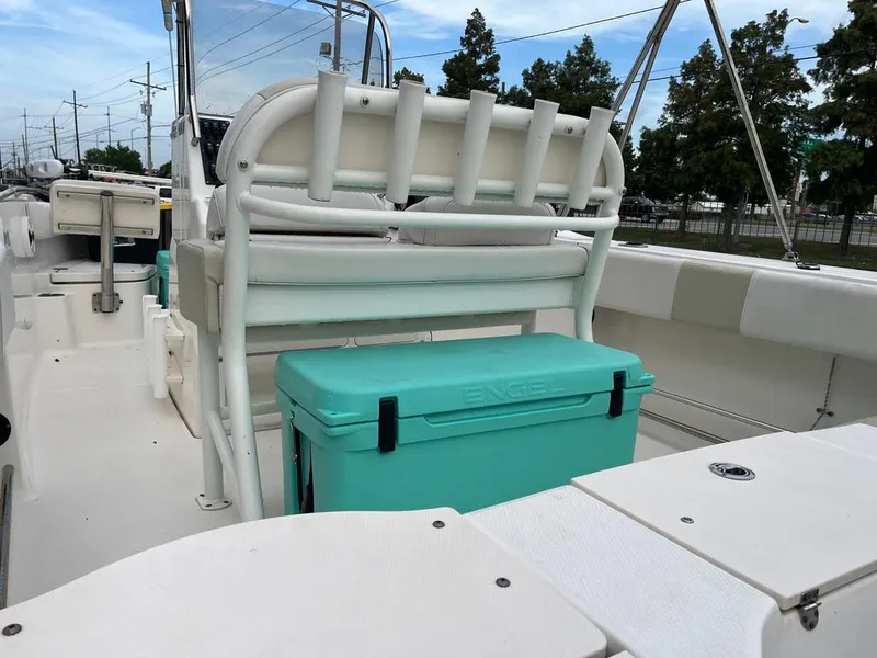Slide: The Image of 2016 Robalo R200 Center Console boat interior with teal cooler and rod holders. - 9