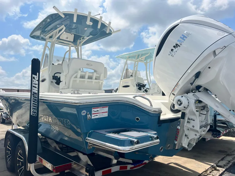 Slide: The Image of 2025 Pathfinder 2600 TRS boat with Yamaha engine on trailer, under blue sky. - 11