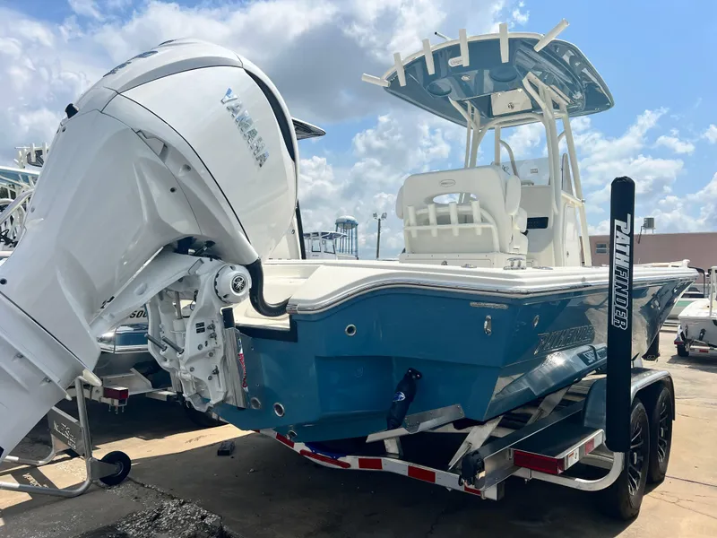 Slide: The Image of 2025 Pathfinder 2600 TRS boat with Yamaha engine on trailer, blue and white design. - 12